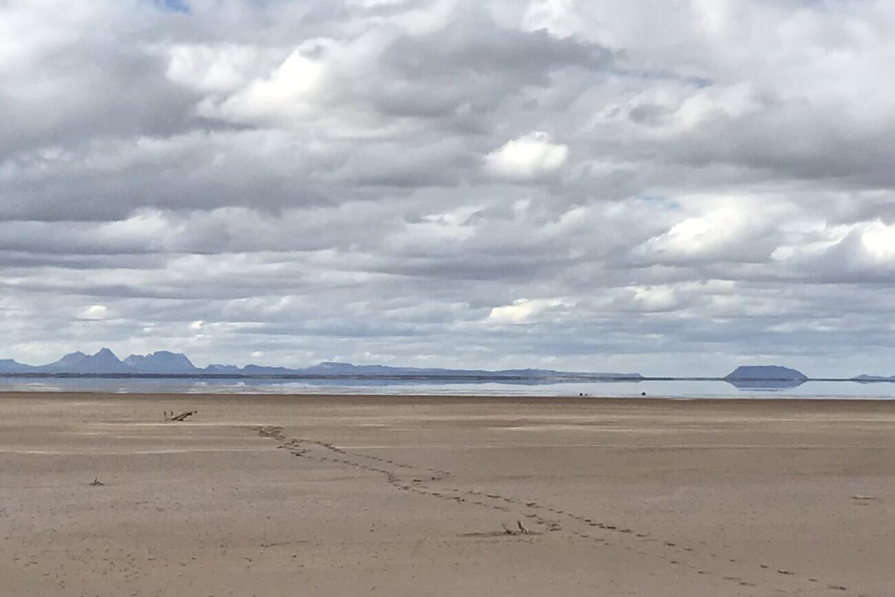 Tidal flats with volcanic cones in the background