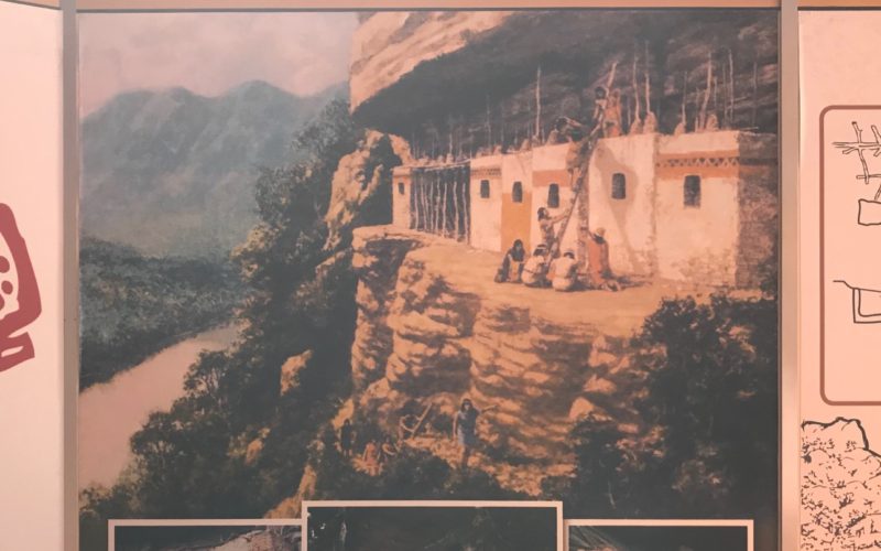 A painting showing the mummies being carried up to their final resting place in chulpas in the cliffs above the lake