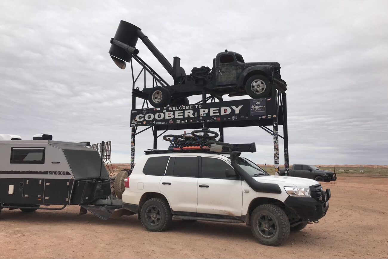 Luckily we are able to cadge a lift to Coober Pedy, arriving as the rain starts and the road is closed behind us
