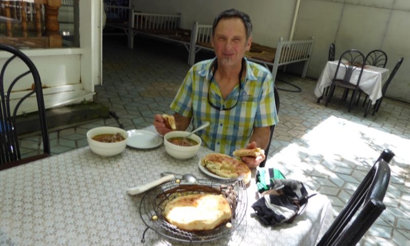 Enjoying roadside dining – a bowl of yummy soup and the round of bread that is served with every meal it seems