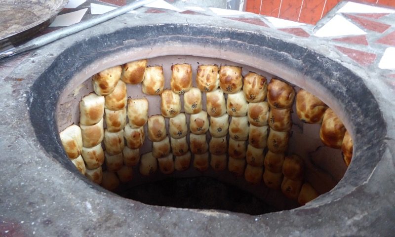 Camcas – mutton filled bread case – baking in a tandoori in Osh bazaar