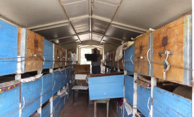 Inside the bee truck, bee man harvesting honey off the trays